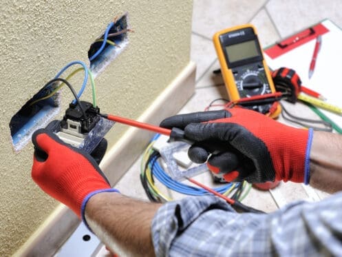 Expert Electrician Working On Outlet